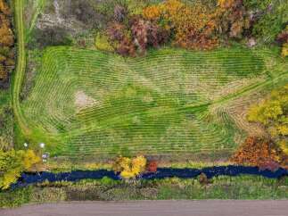 Discover this stunning aerial view of a freshly mowed field, showcasing intricate patterns from above.