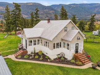 Nestled amidst rolling hills and mature trees, this charming home offers a serene country lifestyle.