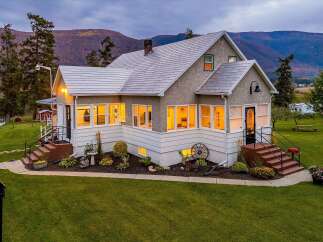 Nestled against a backdrop of rolling hills, this charming home offers a serene retreat.