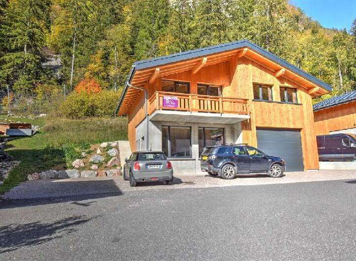 Experience modern living in this stunning wooden chalet, nestled amidst a vibrant autumn forest.