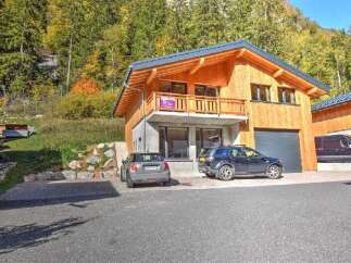 Experience modern living in this stunning wooden chalet, nestled amidst a vibrant autumn forest.