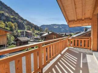 Enjoy breathtaking mountain views from this charming wooden balcony, perfect for your morning coffee or evening relaxation.