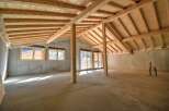 Discover the potential of this unfinished attic space, featuring exposed wooden beams and a vaulted ceiling that create a warm, rustic ambiance.