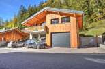 Experience luxury mountain living in this stunning wooden chalet, featuring a modern design and ample natural light.