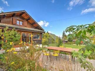 Experience the charm of this rustic wooden chalet nestled amidst a serene mountain landscape.