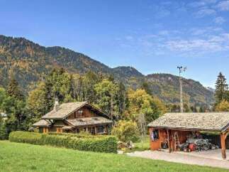 Nestled amidst the vibrant autumn foliage and majestic mountains, this charming wooden chalet offers a serene escape.