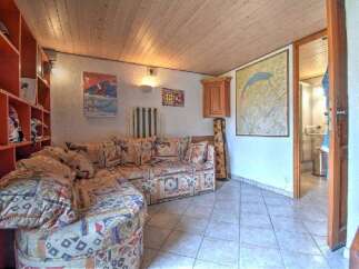 Step into this cozy living area featuring a large, patterned sectional sofa perfect for relaxation.