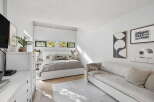 This modern bedroom offers a serene retreat with its minimalist design and abundant natural light.