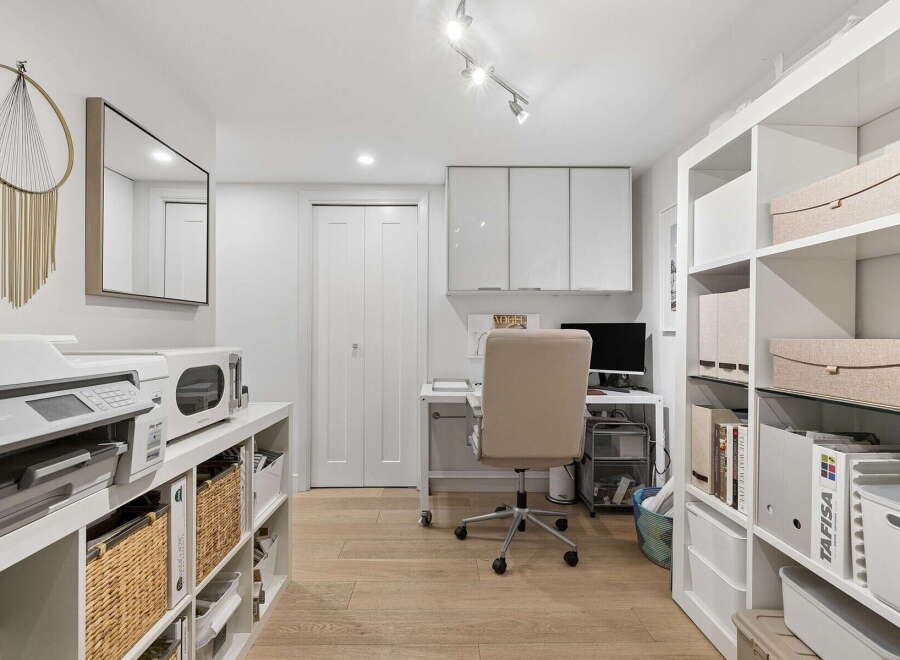 This home office features a modern and organized workspace with ample storage solutions.