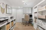 This home office features a modern and organized workspace with ample storage solutions.