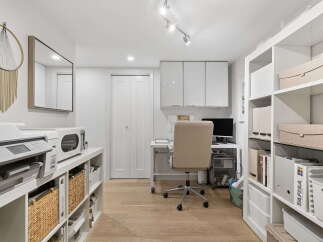 This home office features a modern and organized workspace with ample storage solutions.
