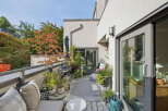 Enjoy outdoor living on this charming balcony, complete with a grill and comfortable seating.