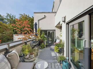 Enjoy outdoor living on this charming balcony, complete with a grill and comfortable seating.
