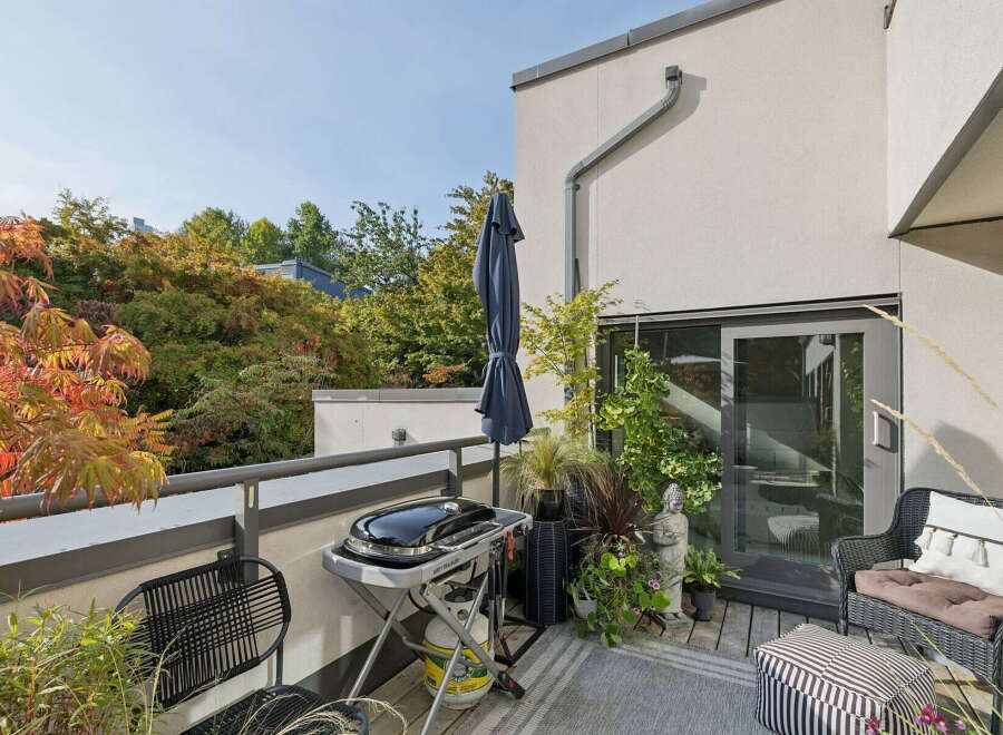 Enjoy outdoor living on this spacious balcony, perfect for entertaining or relaxing.