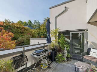 Enjoy outdoor living on this spacious balcony, perfect for entertaining or relaxing.