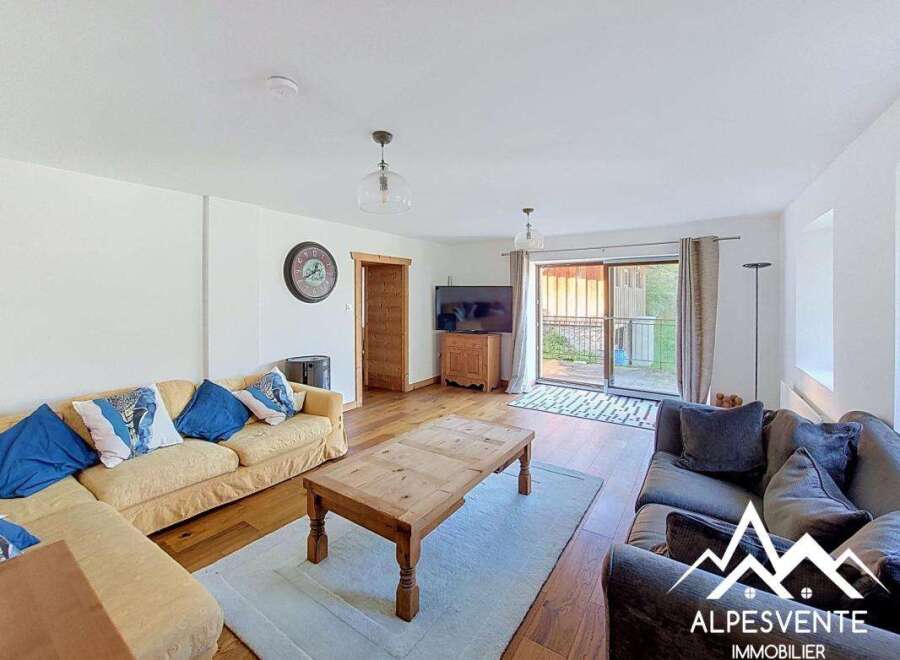 Step into this inviting living room, featuring a comfortable L-shaped sofa and a cozy armchair, perfect for relaxing evenings.