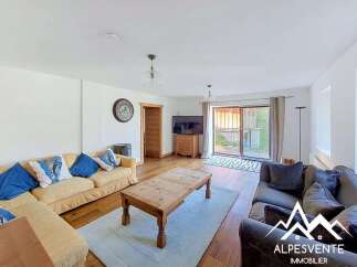 Step into this inviting living room, featuring a comfortable L-shaped sofa and a cozy armchair, perfect for relaxing evenings.