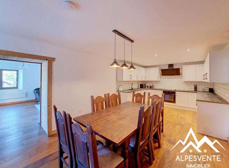 This charming dining area features a rustic wooden table surrounded by sturdy wooden chairs, perfect for family meals.