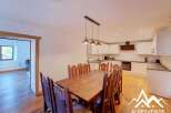 This charming dining area features a rustic wooden table surrounded by sturdy wooden chairs, perfect for family meals.