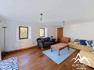 This charming living room features a cozy dark sofa and a bright yellow sectional, perfect for relaxing.