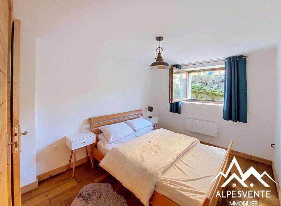 This charming bedroom features a comfortable double bed with crisp white linens, perfect for a restful night's sleep.