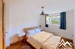 This charming bedroom features a comfortable double bed with crisp white linens, perfect for a restful night's sleep.