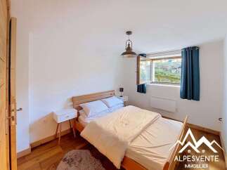 This charming bedroom features a comfortable double bed with crisp white linens, perfect for a restful night's sleep.