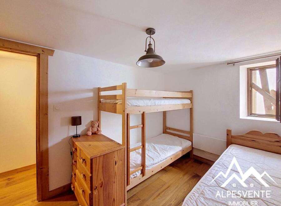 This charming bedroom features a space-saving bunk bed, perfect for families or accommodating guests.