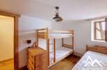 This charming bedroom features a space-saving bunk bed, perfect for families or accommodating guests.
