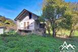 Discover this charming property nestled in a serene mountain landscape, perfect for those seeking tranquility and nature.
