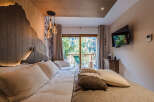 Experience ultimate comfort in this luxurious bedroom, featuring a king-size bed with plush pillows and a cozy duvet.