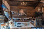 Experience rustic luxury in this stunning mountain lodge living room, featuring a large lion artwork as a focal point.