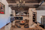 Experience luxury living in this stunning dining area, featuring a unique wooden dining table with a glass top, perfect for hosting memorable meals.