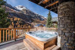 Experience ultimate relaxation with this luxurious hot tub, perfectly situated on a private balcony with breathtaking mountain views.