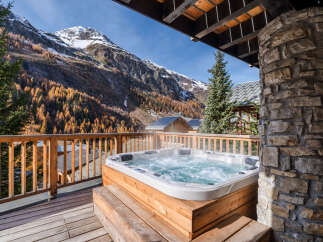 Experience ultimate relaxation with this luxurious hot tub, perfectly situated on a private balcony with breathtaking mountain views.