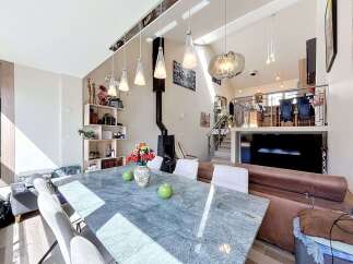 Experience modern living in this spacious open-concept home, featuring a stunning marble dining table perfect for gatherings.