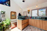 Discover this charming kitchen featuring sleek wooden cabinetry and a stunning marble countertop.