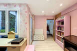 Step into a charming room designed with a delightful pink butterfly-themed wallpaper, creating a whimsical and inviting atmosphere.