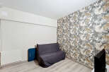 This room features a stylish dark grey sofa bed, perfect for maximizing space in a modern living area.