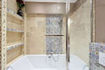 Experience luxury in this stunning bathroom, featuring a deep soaking tub complemented by a sleek glass shower enclosure.