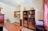 Discover a versatile space perfect for a home office or study, featuring a large wooden desk and ample storage solutions.