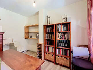 Discover a versatile space perfect for a home office or study, featuring a large wooden desk and ample storage solutions.