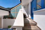 Discover this charming property featuring a striking blue entrance door and a modern architectural design.