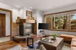 Cozy living room featuring a warm fireplace with a tiled surround and a wooden mantel.
