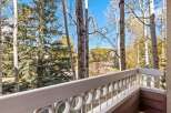 Enjoy the crisp mountain air from this charming balcony, offering picturesque views of aspen and pine trees in their autumn splendor.