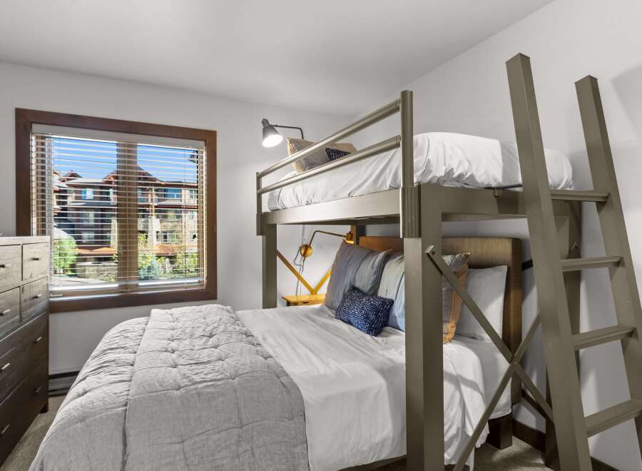 This bedroom features a space-saving bunk bed with a twin-over-twin configuration, perfect for maximizing sleeping arrangements.