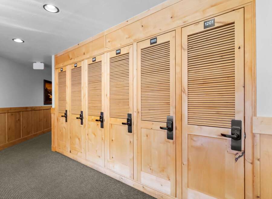 Discover the charm of this property featuring a hallway lined with beautifully crafted wooden doors, each numbered for easy identification.