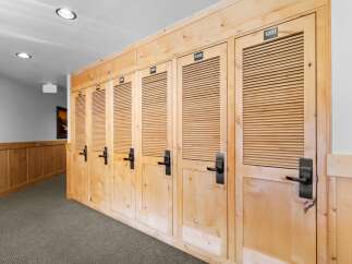 Discover the charm of this property featuring a hallway lined with beautifully crafted wooden doors, each numbered for easy identification.