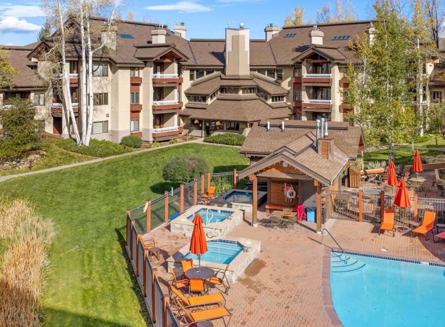Experience luxury living with this stunning property featuring a sparkling blue swimming pool and relaxing hot tubs, perfect for unwinding.