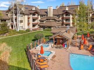 Experience luxury living with this stunning property featuring a sparkling blue swimming pool and relaxing hot tubs, perfect for unwinding.